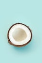 One half of ripe coconut on blue background,top view Royalty Free Stock Photo