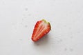 One half of strawberry lies on a light white concrete background. Minimalism. Top View, Copy Space For Your Text Royalty Free Stock Photo