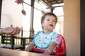 One and half year old baby boy having a meal in the restaurant with his mother Royalty Free Stock Photo