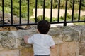 One and a half year old toddler standing ner the wall and looking down...loonley child concept Royalty Free Stock Photo
