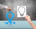 One hand building stack blocks lightbulb the other holding blueprint