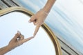 One hand gently touches the reflection of the same hand on the mirror Royalty Free Stock Photo