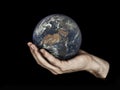 One hand holding planet Earth isolated on black. Elements of this image furnished by NASA. Royalty Free Stock Photo