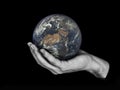 One hand holding planet Earth isolated on black. Royalty Free Stock Photo