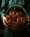 One hand holds a basket of crayfish. A person holding a basket full of cooked craws Royalty Free Stock Photo