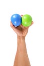 one hand holds two stress balls isolated on white Royalty Free Stock Photo