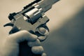 One hand is large silver heavy revolver and aims into the air Royalty Free Stock Photo