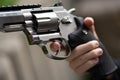 one hand is large silver heavy revolver and aims into the air Royalty Free Stock Photo