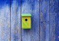 one hand-made birdhouse on a blue wooden wall in the spring garden Royalty Free Stock Photo