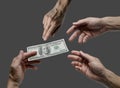 One hand offer one hundred dollar bill to others Royalty Free Stock Photo