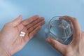 In one hand one bright pill in another many in shadow. concept of effective medicine