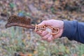 one hand of a worker holds a brown old rusty iron metal brush Royalty Free Stock Photo