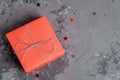 One handcrafted festive presents wrapped in red paper