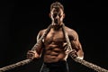 One handsome sexual strong young man with muscular body holding rope Royalty Free Stock Photo
