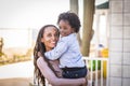 One happy black athnic family afro american mother and son hug together outside home in outdoor leisure activity. Mommy and little Royalty Free Stock Photo