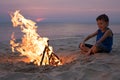 One happy little boy playing on the beach at the sunset time Royalty Free Stock Photo