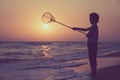 One happy little boy playing on the beach at the sunset time. Royalty Free Stock Photo