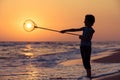 One happy little boy playing on the beach at the sunset time. Royalty Free Stock Photo