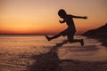 One happy little boy playing on the beach at the sunset time Royalty Free Stock Photo