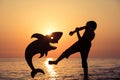 One happy little boy playing on the beach at the sunset time. Royalty Free Stock Photo