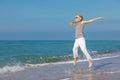 One happy little girl playing on the beach at the day time Royalty Free Stock Photo