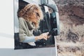 One happy woman tourist outside the window  her camper van using modern gps navigator device to plan the next destination. Travel Royalty Free Stock Photo