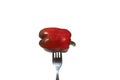 There is a whole red bell pepper on the fork. Royalty Free Stock Photo