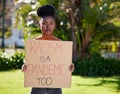 One has a moral responsibility to disobey unjust laws. a young woman protesting outside in the park.