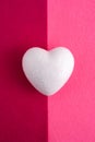 One white foam heart on felt.