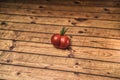 One heart or butt shaped red tomato on a wooden background Royalty Free Stock Photo