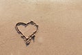 One Heart Drawn in the Sand on a Beach.soft wave of the sea.Romantic love. true love.Beige beach.Copy space