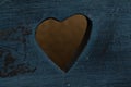 Heart shaped hole in old blue wood Royalty Free Stock Photo