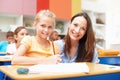 One of her brightest students. Portrait of an attractive young teacher helping a student with her schoolwork. Royalty Free Stock Photo