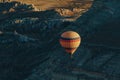 One Hot air balloon flying in Goreme national park, fairy chimneys, Royalty Free Stock Photo