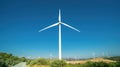 One huge wind generator in front of Oreites wind farm in Cyprus against clear blue sky. Wide angle landscape panorama Royalty Free Stock Photo