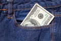 One hundred American dollars bill in a pocket of blue jeans Royalty Free Stock Photo