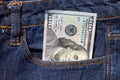 One hundred American dollars bill in pocket of blue jeans Royalty Free Stock Photo