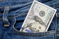 One hundred American dollars bill in pocket of blue jeans Royalty Free Stock Photo