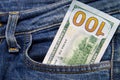 One hundred American dollars bill in the pocket of blue jeans Royalty Free Stock Photo