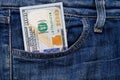 One hundred American dollars bill in pocket of blue jeans Royalty Free Stock Photo