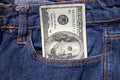 One hundred American dollars bill in pocket of blue jeans Royalty Free Stock Photo