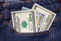 One hundred American dollars bills in pocket of blue jeans Royalty Free Stock Photo