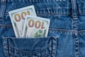 One hundred American dollars bills in pocket of blue jeans Royalty Free Stock Photo