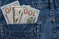 One hundred American dollars bills in pocket of blue jeans Royalty Free Stock Photo