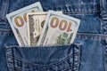 One hundred American dollars bills in pocket of blue jeans Royalty Free Stock Photo