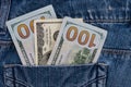 One hundred American dollars bills in pocket of blue jeans Royalty Free Stock Photo