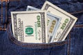 One hundred American dollars bills in pocket of blue jeans Royalty Free Stock Photo