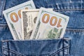 One hundred American dollars bills in pocket of blue jeans Royalty Free Stock Photo