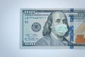 One hundred dollar banknote. Bill with medical face mask on Benjamin Franklin. Economic crisis concept Royalty Free Stock Photo