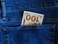 One hundred dollar banknote money in back pocket jeans pants background texture. 100 dollar bill close up Royalty Free Stock Photo